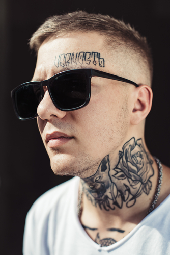 guy with face and neck tattoo