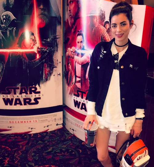 vamp posing by star wars poster