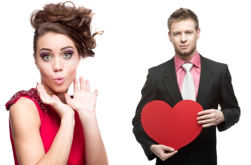 man giving heart to woman